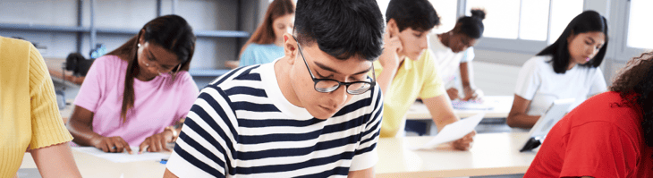 students studying or taking exam at their desks students studying or taking exam at their desks